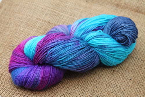 Hand painted sock yarn in turquoise, magenta, purple and navy.