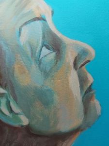 detail of acrylic painting work-in-progress showing profile of the artist on turquoise background. The basic areas of darks, midtones and lights are blocked in using shades mixed with raw umber, naples yellow, buff titanium and turquoise. The face is angled looking upwards with eyebrows raised and expression pensive